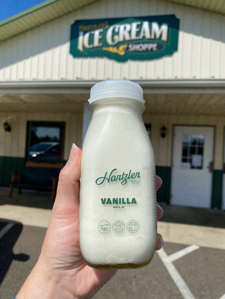 A glass bottle of Vanilla Milk in front of Hartzler's Dairy in Wooster, Ohio.
