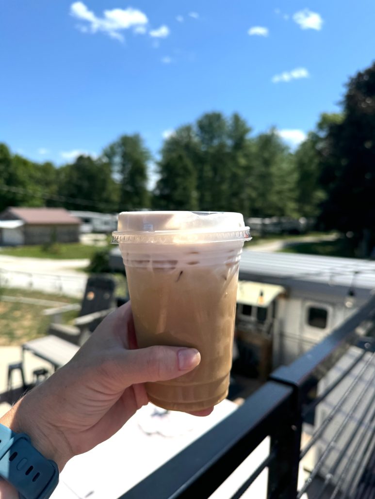 An iced latte with cold foam at Oasis 2.0 airstream coffee shop.