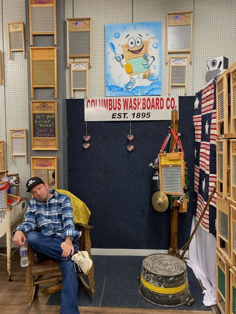 A man sitting in a rocking chair at Columbus Washboard Co in downtown Logan, Ohio.