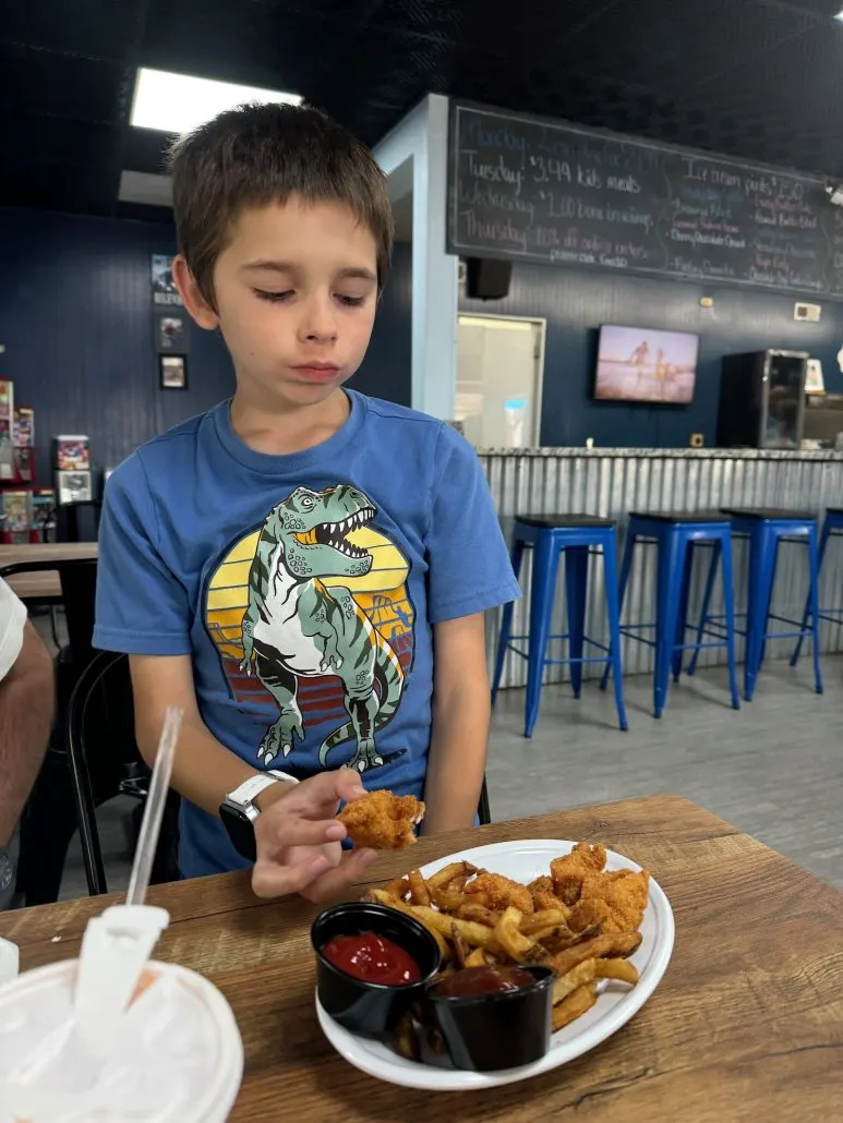 A boy eating chicken nuggets at TheFeed in Logan, Ohio.