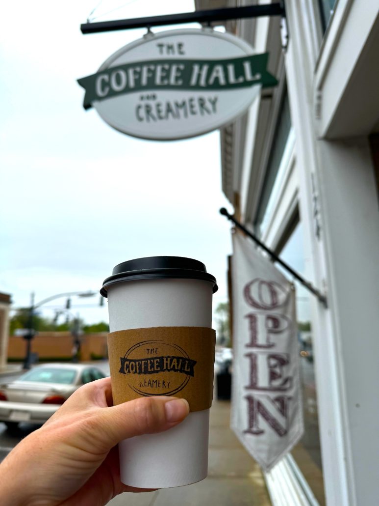 A coffee cup held up outside of the Coffee Hall and Creamery in downtown Marysville, Ohio.