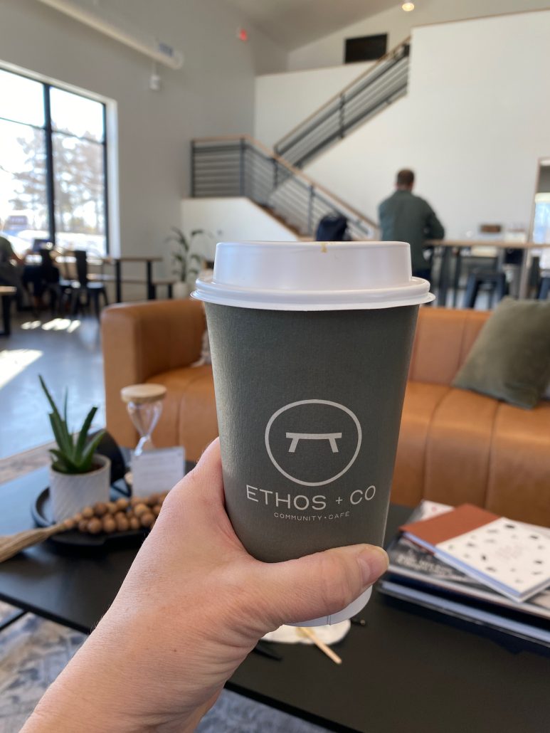 A coffee cup held up inside Ethos + Co Cafe in Westerville, Ohio.