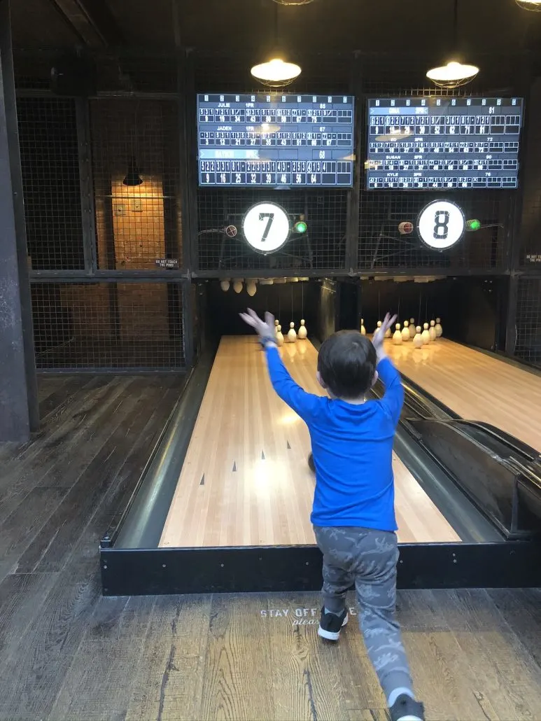 A boy playing duck pin bowling at Pins Mechanical in downtown Columbus.