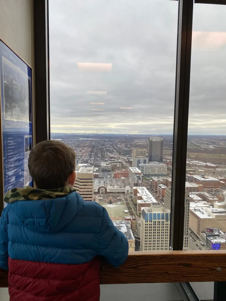 A boy looking out of the observation deck at Rhodes Tower.