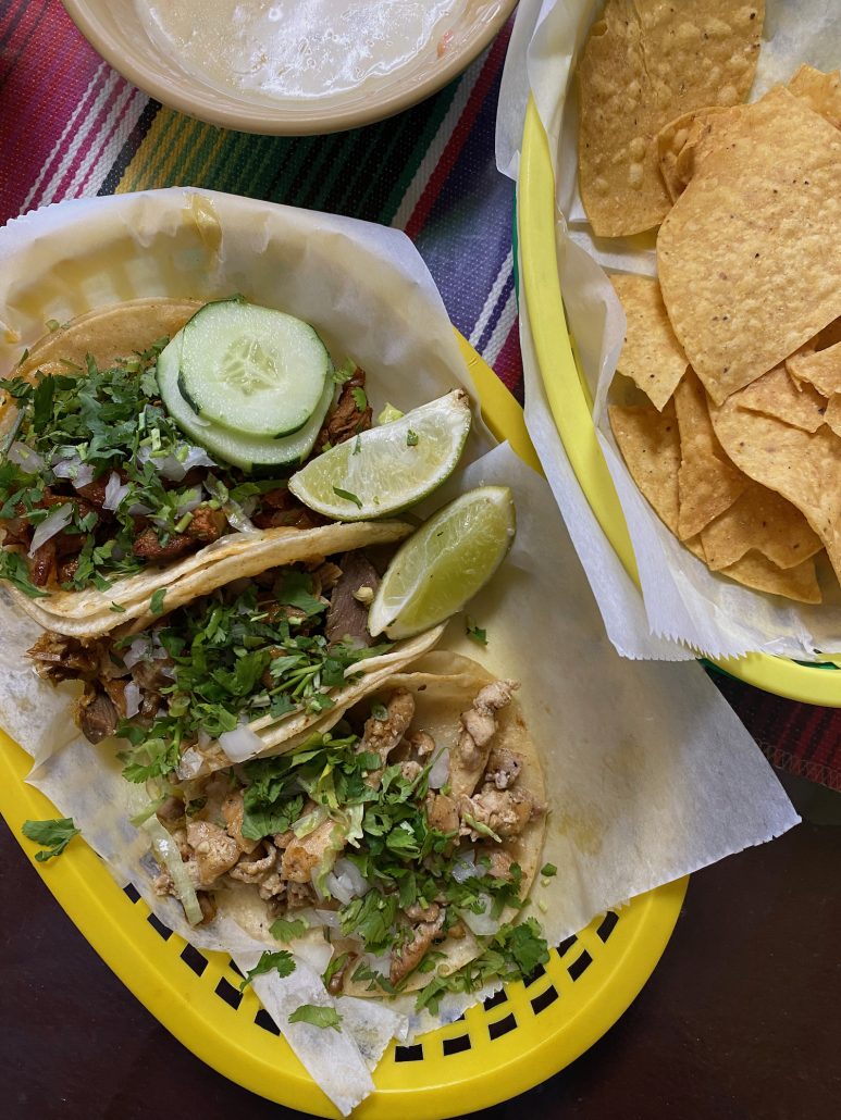 A plate of tacos with a bowl of chips and queso from Tacos don Deme in Central Ohio.