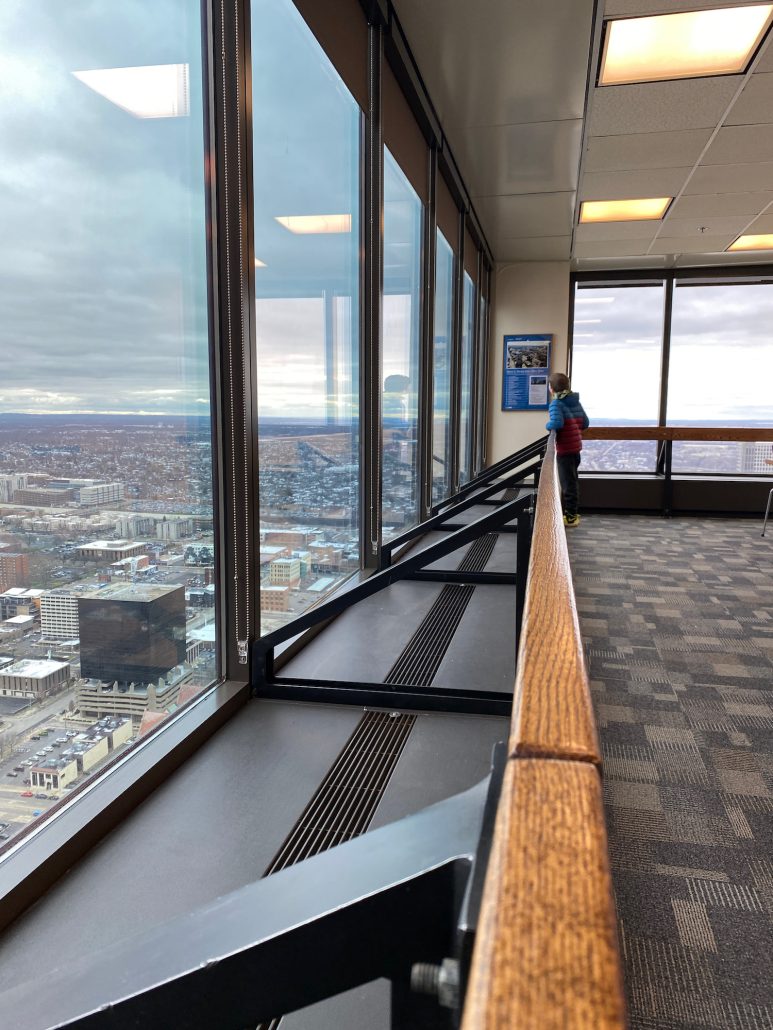 A boy looking over downtown Columbus from the top of the Observation Deck at Rhodes Tower.