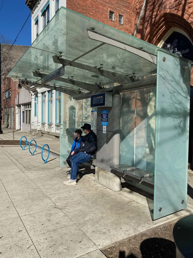 A father and son waiting for the Cincinnati Connector.