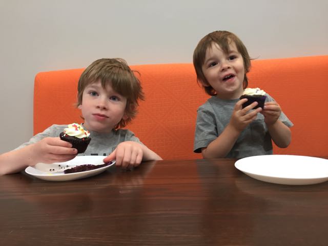 Two boys eating cupcakes at Fresh Start Cafe and Bakery in downtown Delaware.