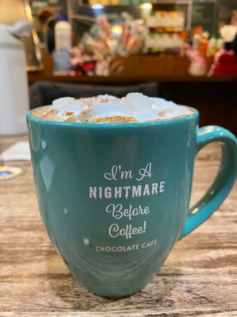 A mug of Mexican Hot Chocolate topped with whipped cream from Chocolate Cafe.