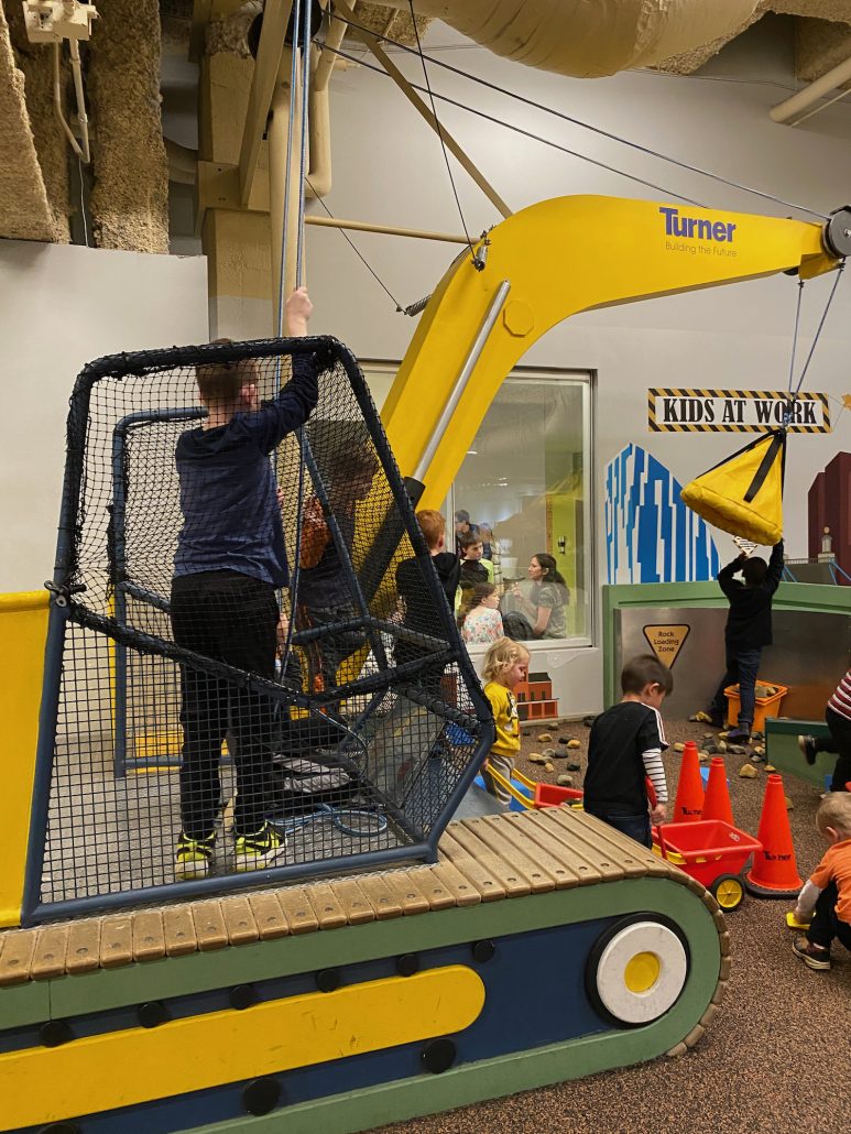 A boy operating a crane at Cincinnati Children's Museum.