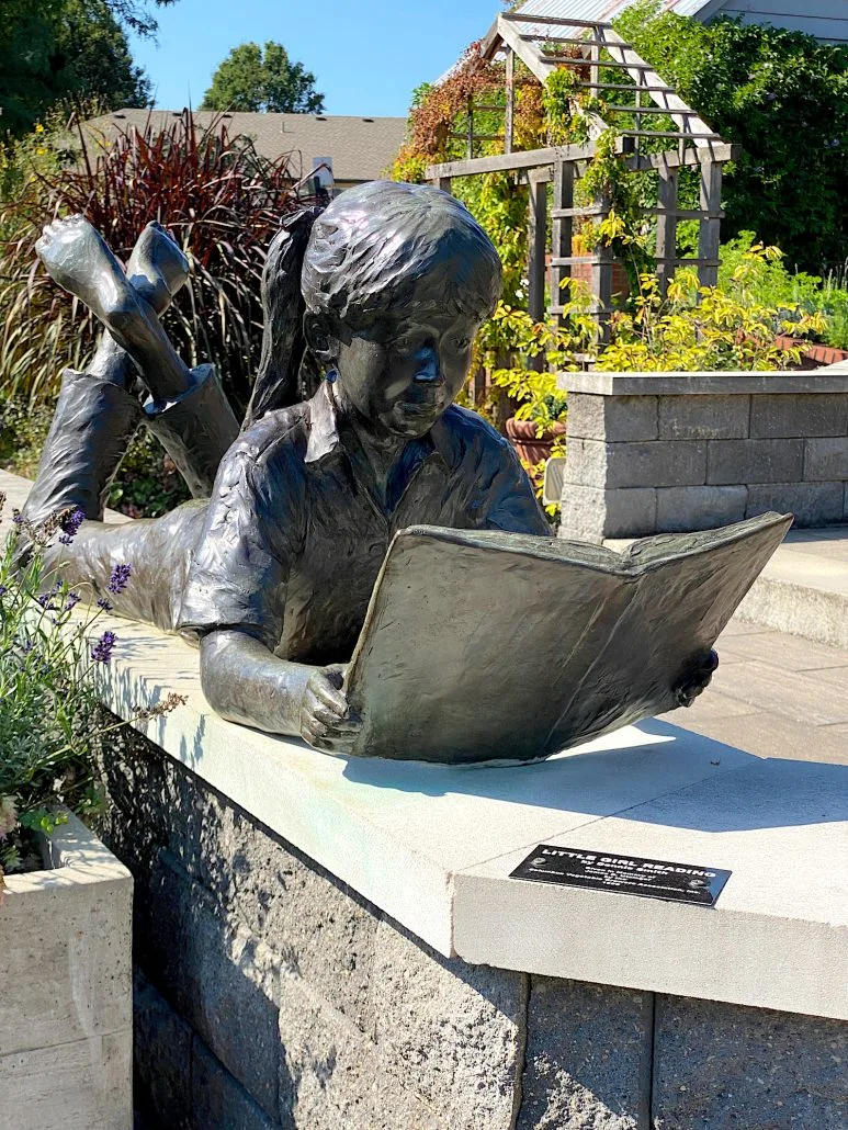 Little Girl Reading statue at the Gardens at Gantz in Grove City.