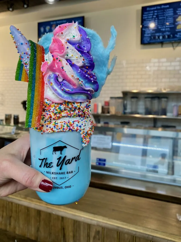 The Unicorn Shake topped with whipped cream and candy.
