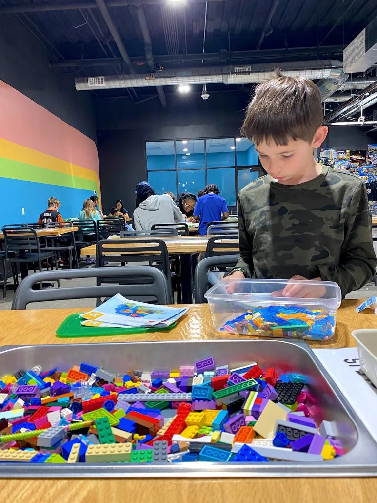 A boy building a LEGO set at The Brickery Cafe in Newport on the Levee.