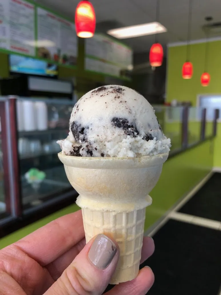 A scoop of cookies and cream ice cream on a cake cone at Laguna Mexican Street Food & Ice Cream in Columbus OH.