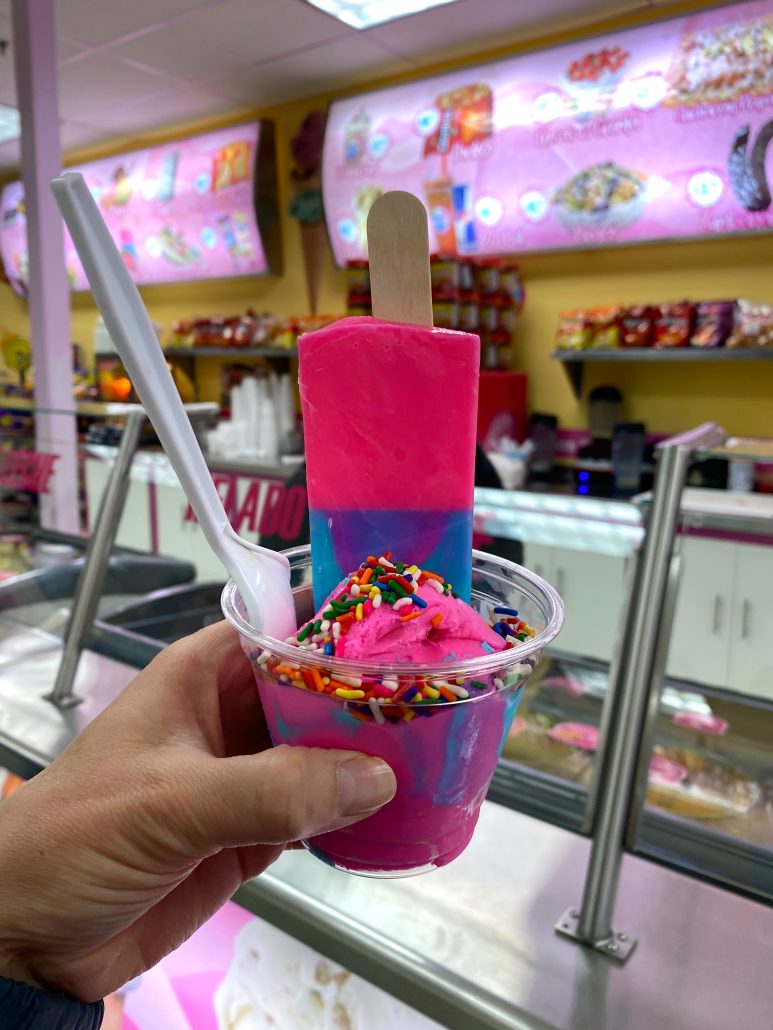 A paleta stuck inside a cup of bubble gum ice cream with sprinkles at Dulce Vida, a Mexican ice cream shop in Columbus, Ohio.