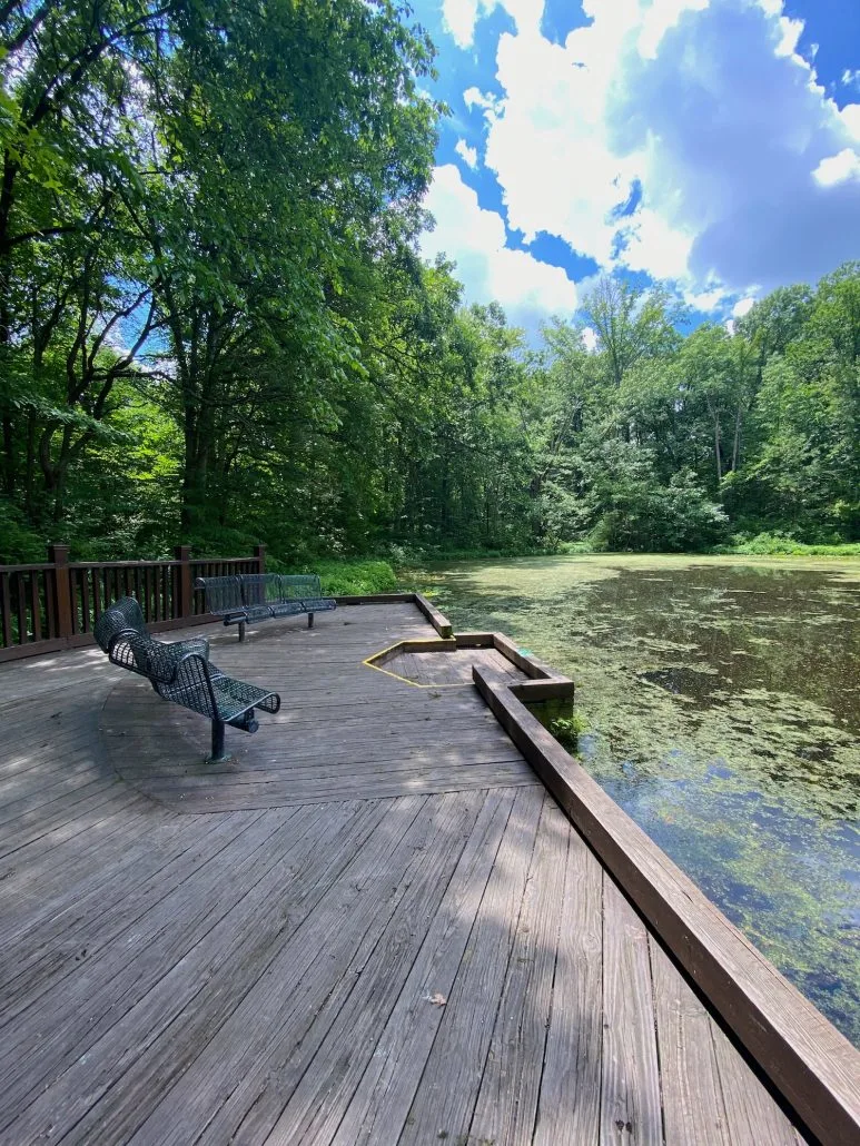 A deck and seating area overlooking. Ashton Pond.