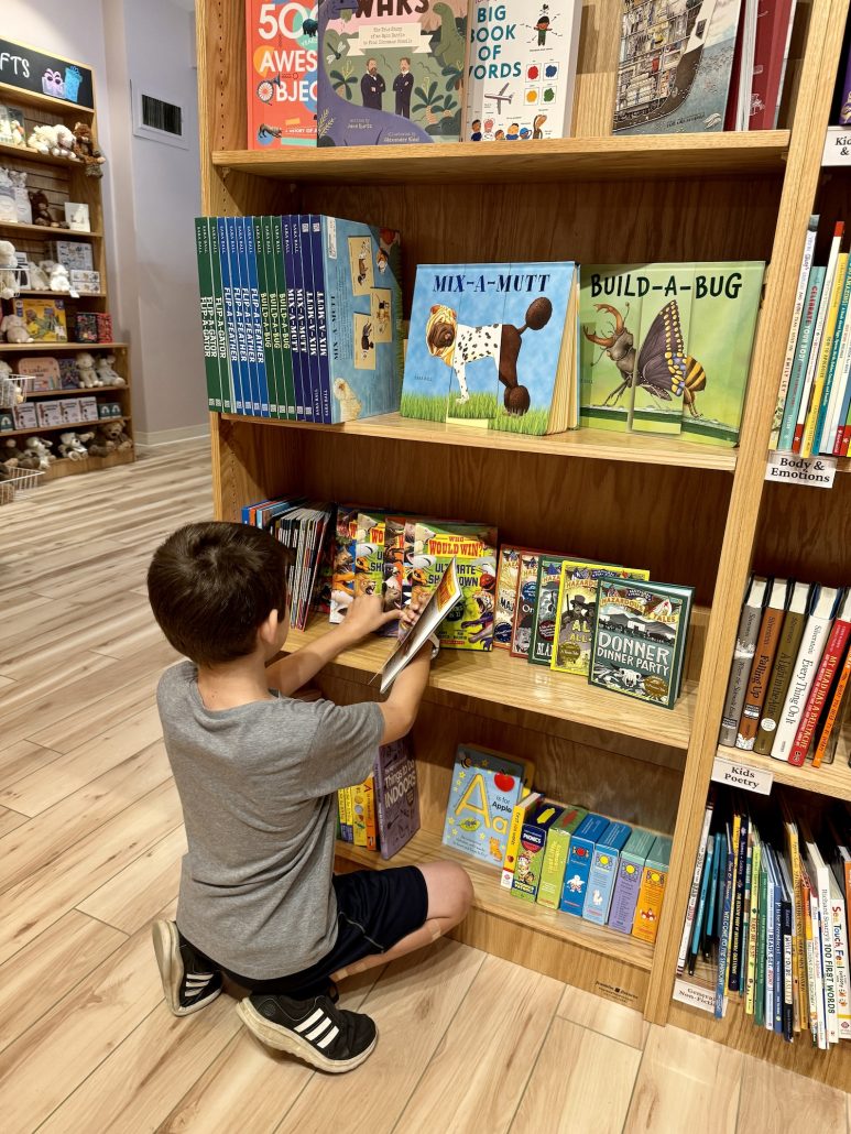 A boy picking out a book at Storyline Bookshop in Central Ohio.