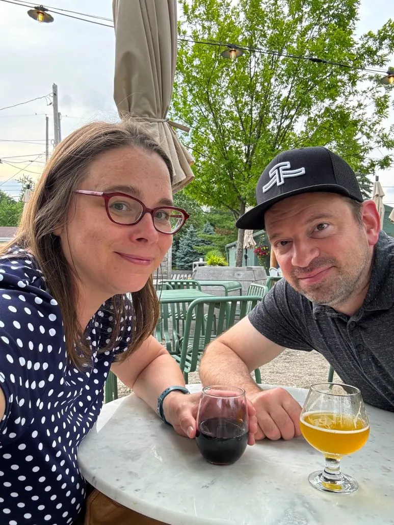 A man and woman having a drink on the patio of Hillgarten Beer and Wine in Hilliard, Ohio.