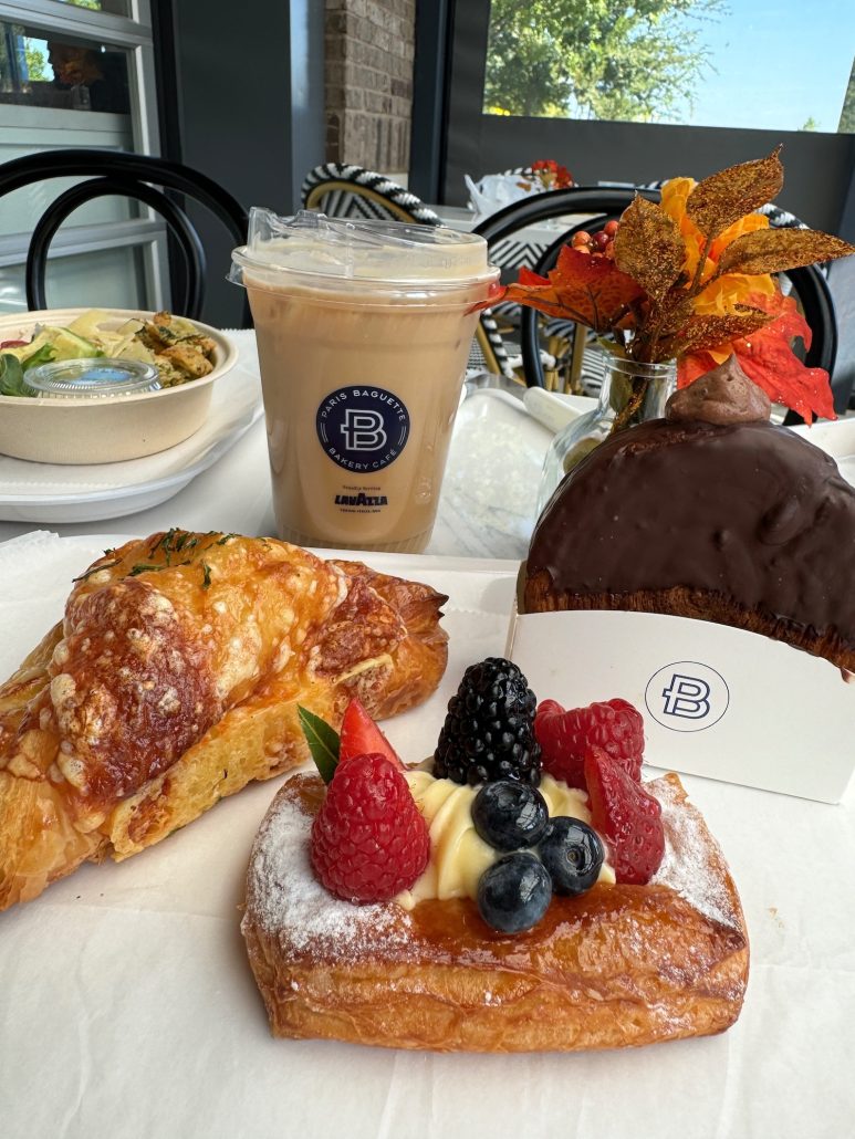 Several offerings from Paris Baguette including a fruit tart, iced latte, and pastries.