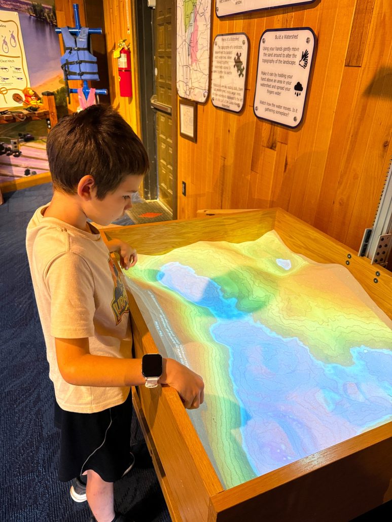  A boy playing at the sand table at Alum Creek State Park Visitor Center.