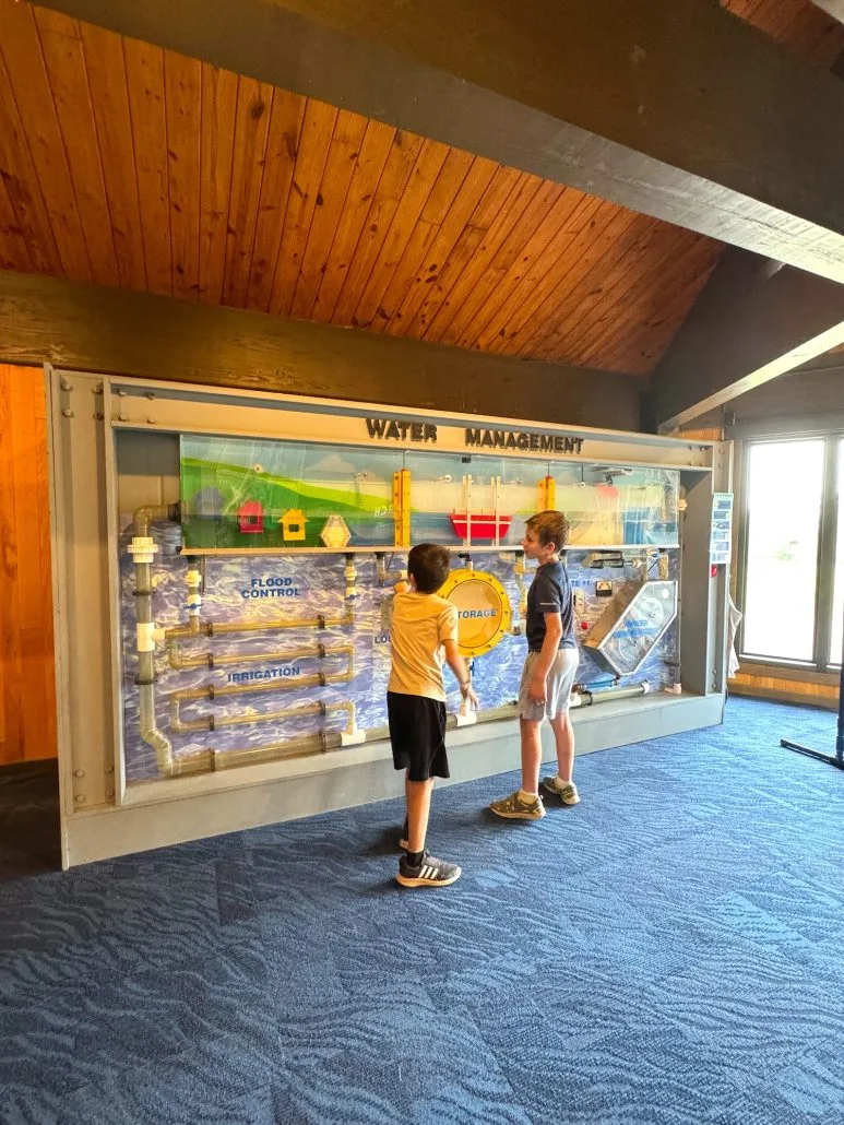 Two boys interacting with the Water Management activity at the Visitor Center.