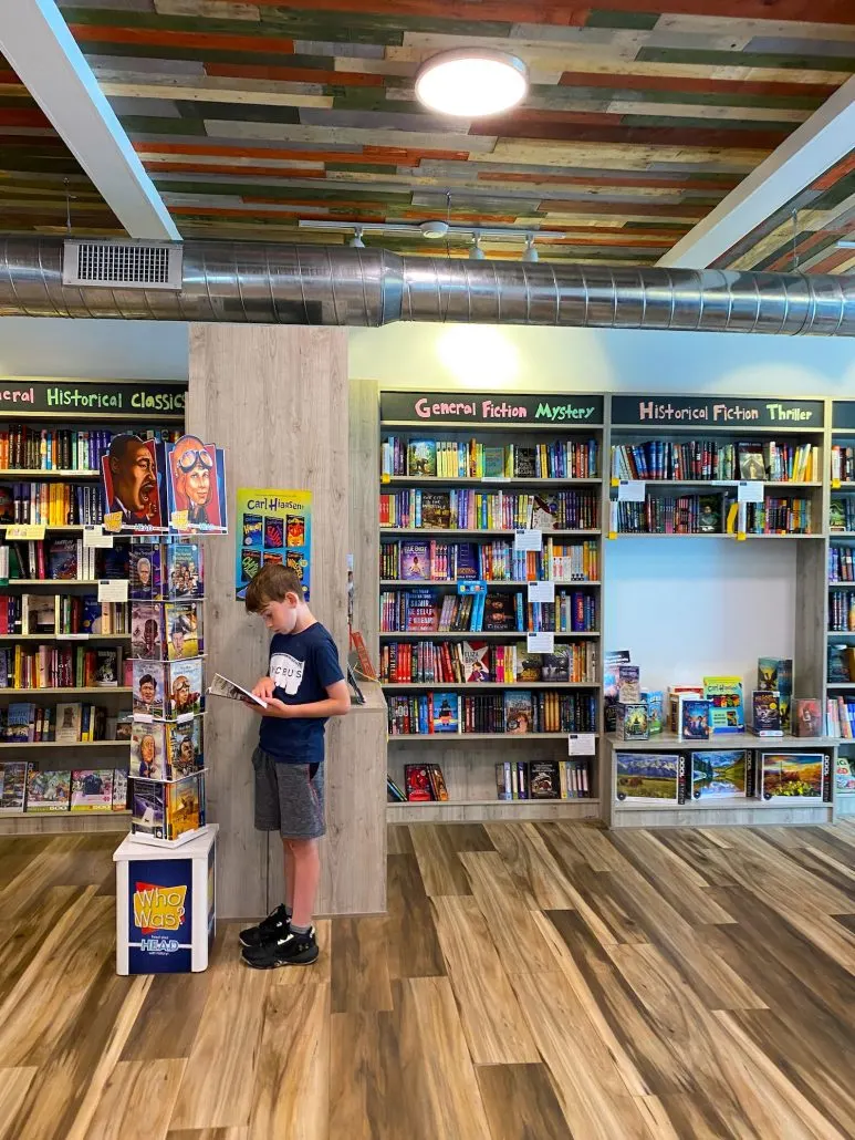 A boy looking at a book at Beanbag Books in Delaware, Ohio.