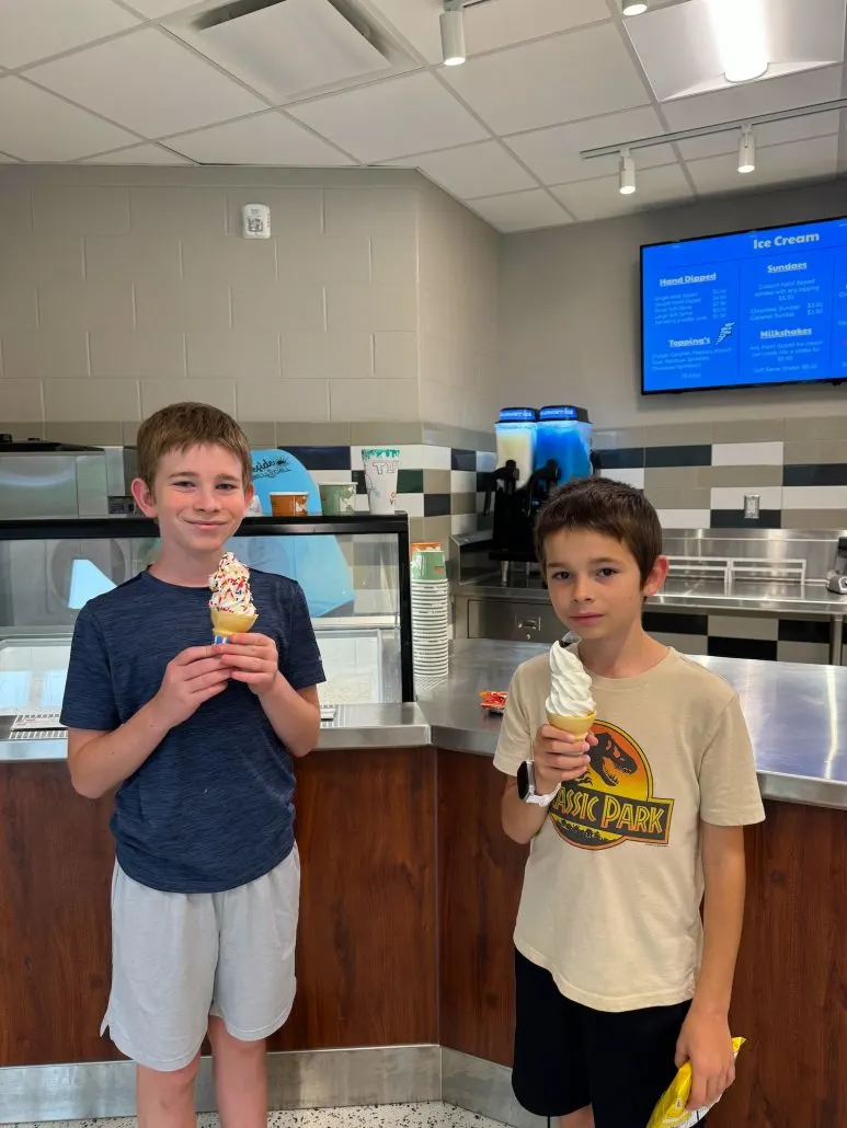 Two boys holding ice cream cones inside the Marina.