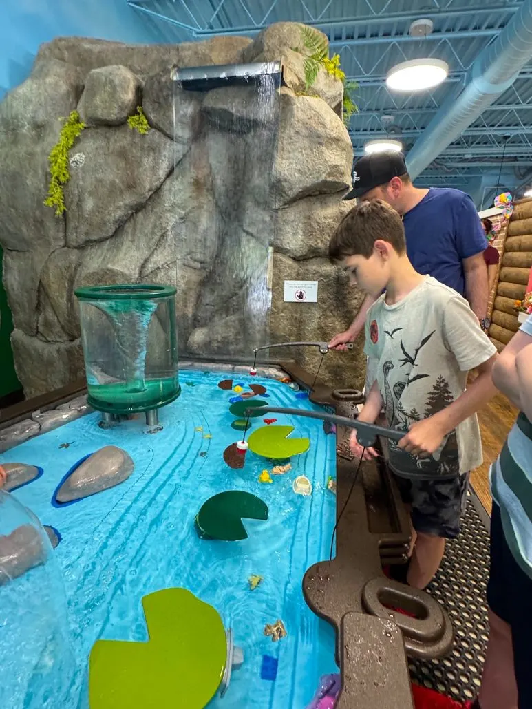 A father and son "fishing" at the water table at the Hocking Hills Children's Museum in Logan, Ohio.