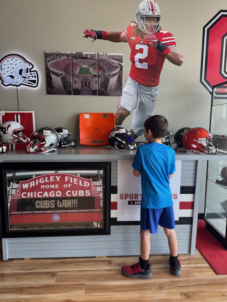 A boy looking at sports memorabilia at Father Son Sports Cards in Powell.