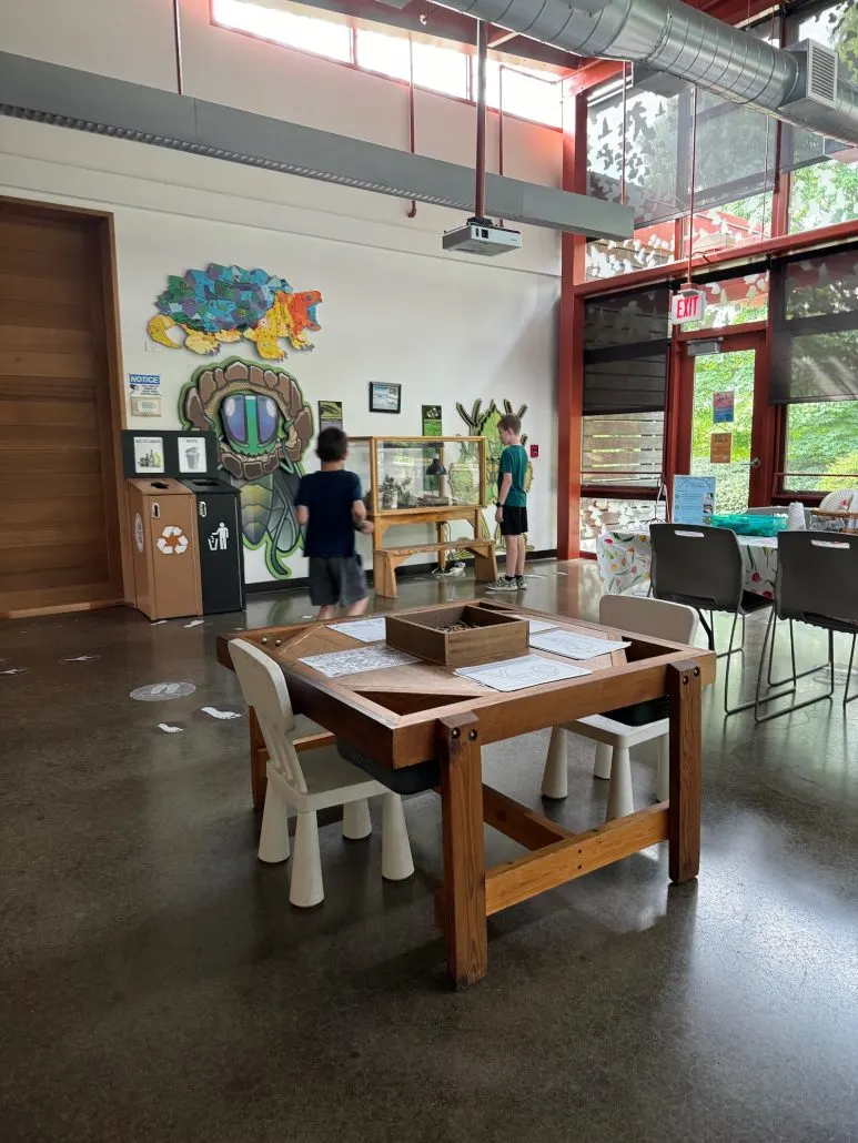 2 Boys looking at items of interest in the Grange Insurance Audubon Center.