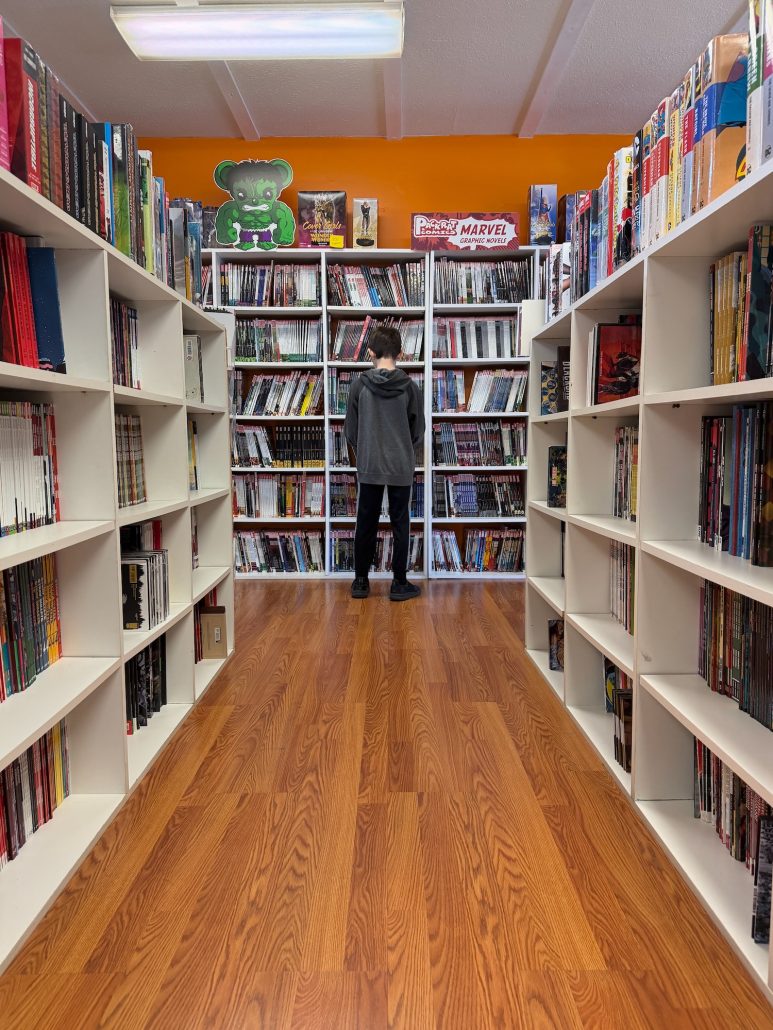 A boy looking at graphic novels at Packrat Comics in Hilliard, Ohio.