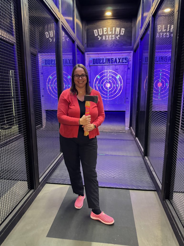 A woman holding an axe at Dueling Axes in Grove City, Ohio.
